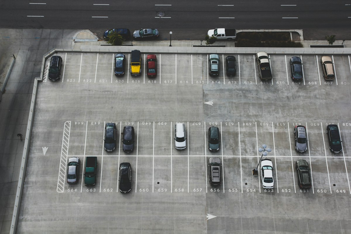 Numbered parking stall striping and directional arrows on a commercial lot